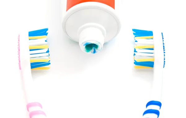 Pair of toothbrush and tube of paste on white — Stock Photo, Image