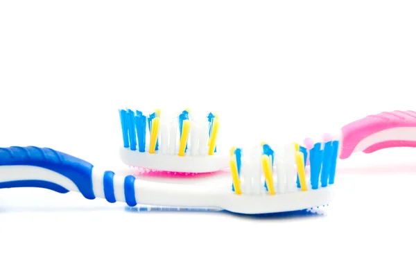 Blue and pink toothbrushes on white Royalty Free Stock Images
