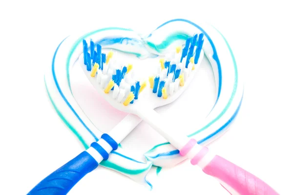 Two toothbrushes in heart — Stock Photo, Image