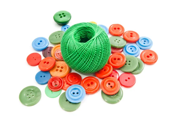 Green ball of thread and buttons — Stock Photo, Image