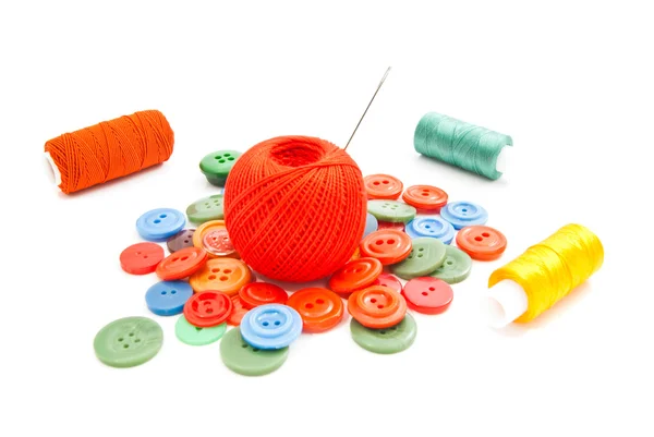 Needle, buttons and tangles of thread — Stock Photo, Image