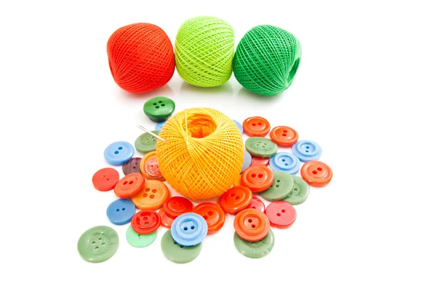 Colorful buttons, needle and tangles of thread — Stock Photo, Image