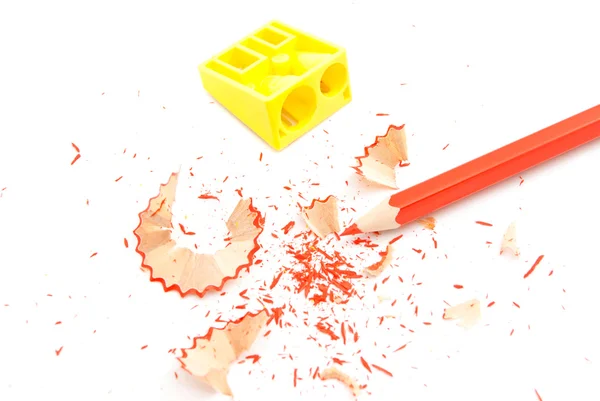Red pencil, pencil sharpener and shavings — Stock Photo, Image
