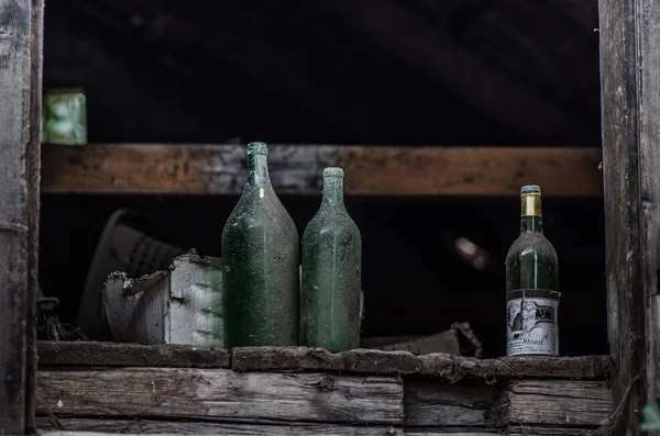 Wine bottles in old house — Stock Photo, Image