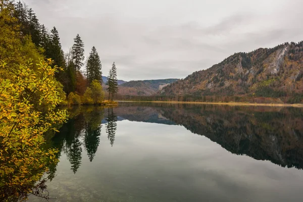Sonbaharda yürüyüş yaparken göldeki çam ağaçlarından ve dağlardan yansıyan cennet manzarası.