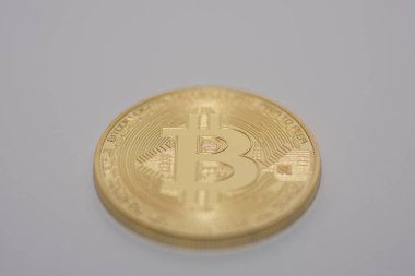 Gri arka planda duran tek bir altın bitcoin orta görünümde