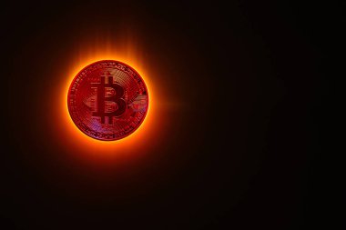 red glowing bitcoin instead a burning sun with black background clipart