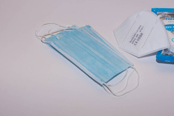 different masks and white better FFP2 or KN95 mask on light gray background