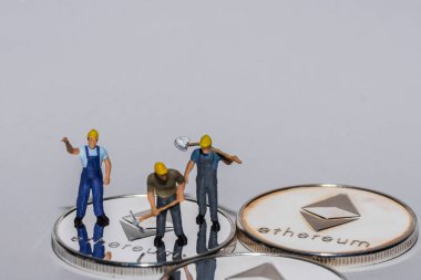 Gümüş parlayan eter üzerinde duran üç madenci gri arka plan görünümlü kripto para birimi.