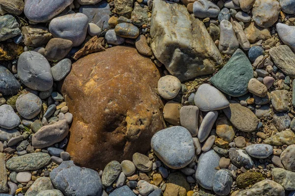 colorful small and big stones in the sun  while walking