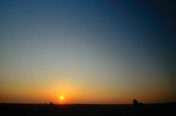 Zonsopgang en vlakke landschap — Stockfoto