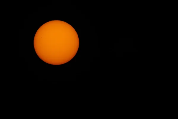 Orange sun and black sky — Stock Photo, Image