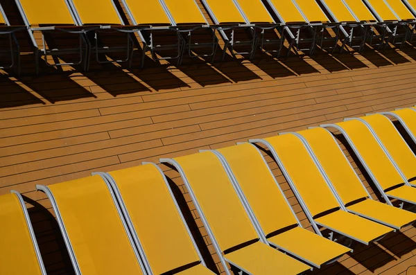 Many yellow sunbeds — Stock Photo, Image