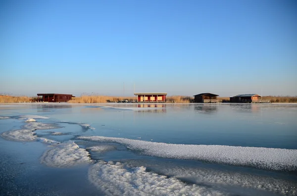 Colorful shacks on frozen lake — Stock Photo, Image