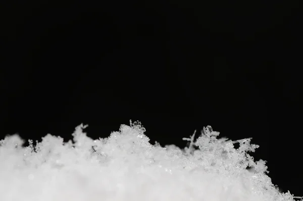 Fresh crystals in the snow on black — Stock Photo, Image