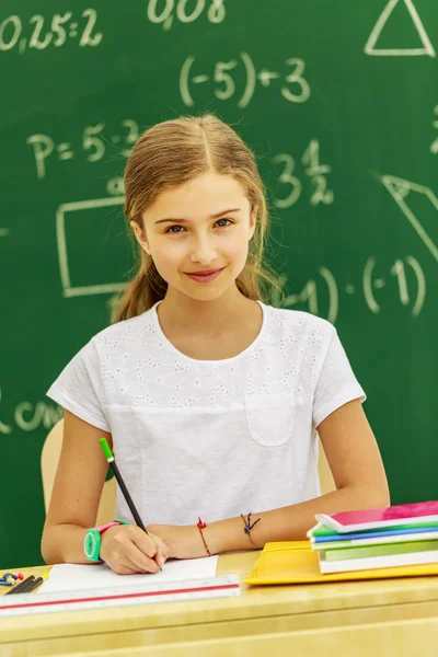 Back to school - beautiful schoolgirl in the classroom — Stock Photo, Image