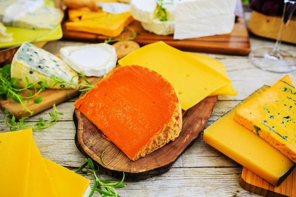 El queso - los tipos diferentes del queso a la mesa de madera — Foto de Stock