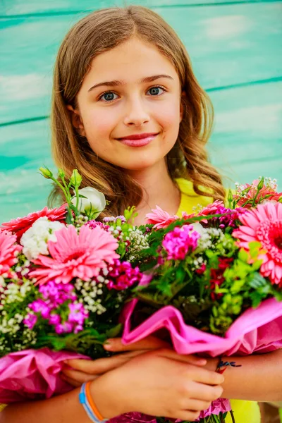 Girl with a bouquet of colorful flowers — Stock Photo, Image