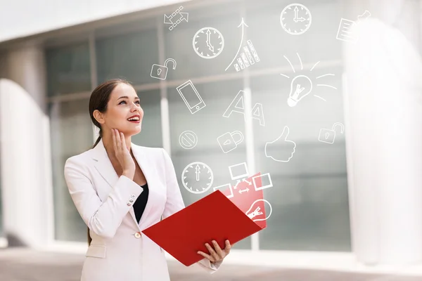 Business woman with icons overhead — Stock Photo, Image