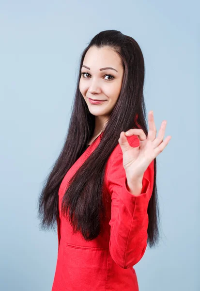 Young beautiful woman shows OK sign — Stock Photo, Image