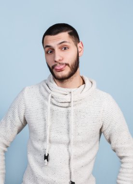 Young handsome man showing tongue