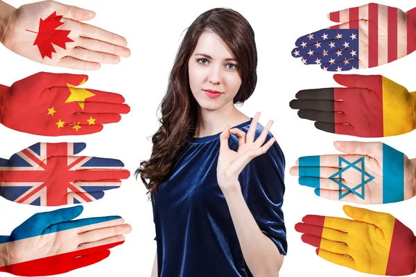 Woman and many hands with different flags — Stock Photo, Image