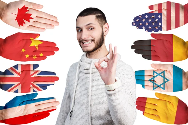 Homem e muitas mãos com bandeiras diferentes — Fotografia de Stock
