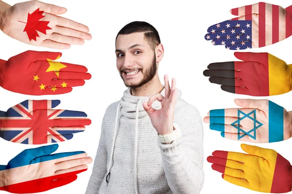 Man and many hands with different flags — Stock Photo, Image