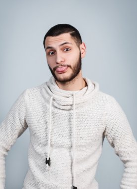 Young handsome man showing tongue