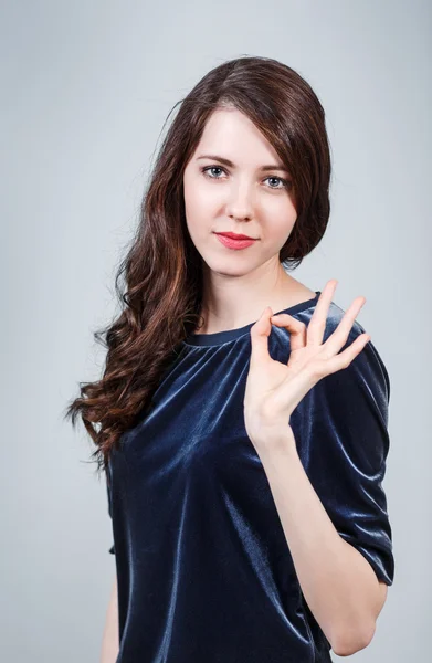 Young beautiful woman shows OK sign — Stock Photo, Image