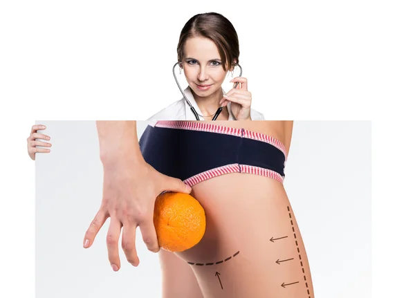 Doctor holds placard with woman battocks — Stock Photo, Image