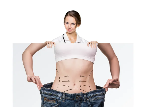 Doctor holds placard with woman battocks — Stock Photo, Image