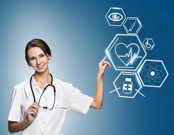 Female doctor working with healthcare icons Stock Photo