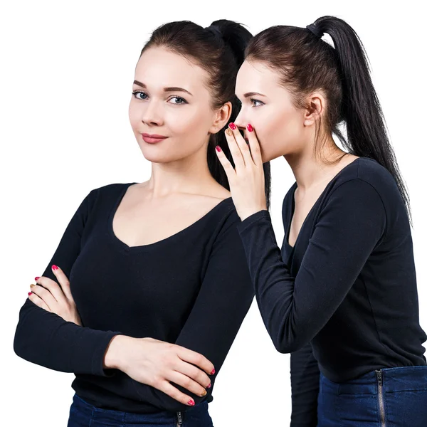 Two smiling girls whispering gossip — Stock Photo, Image