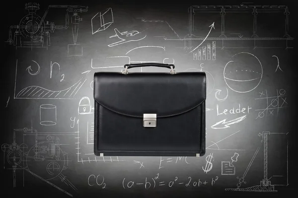Black leather briefcase over gray wall — Stock Photo, Image