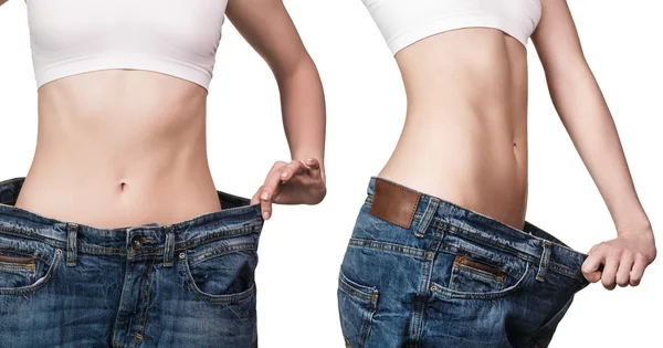 Young slim woman in oversized blue jeans — Stock Photo, Image