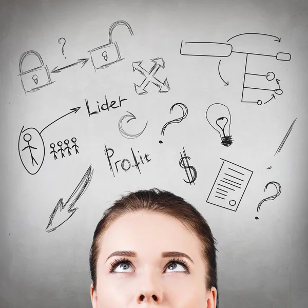 Young woman looking up on business plan — Stock Photo, Image