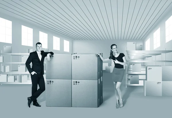 Young woman and man in warehouse — Stock Photo, Image