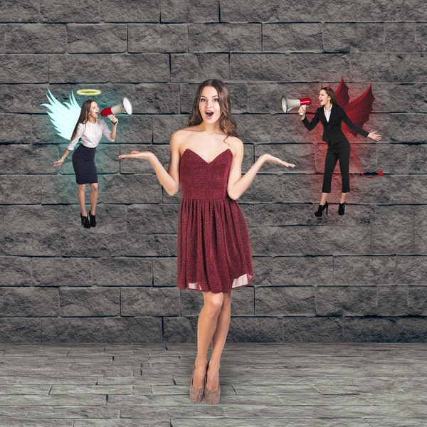 Pretty young woman thinks, an angel and a devil — Stock Photo, Image