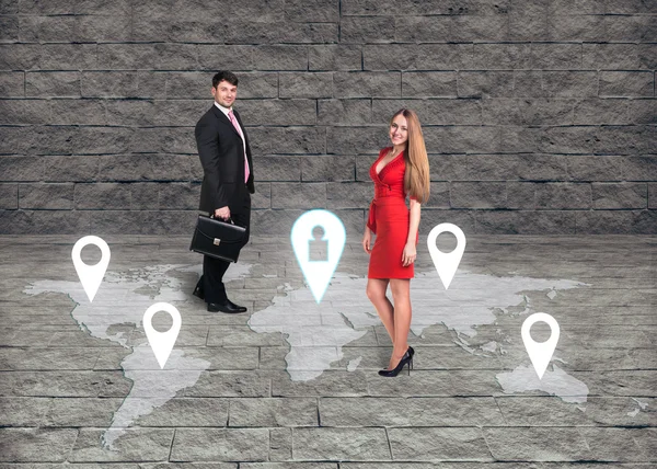 Man and woman standing in front of an earth map — Stock Photo, Image
