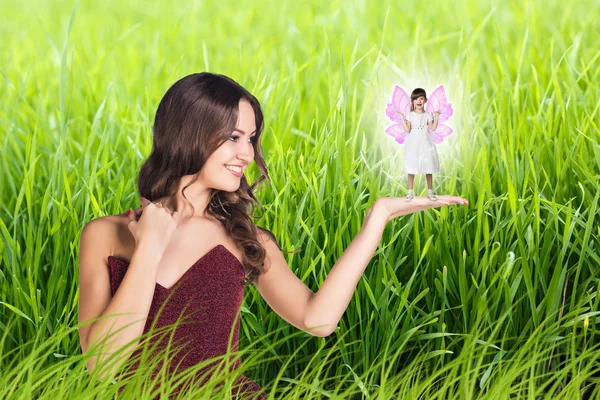 Beautiful woman with little girl with fairy wings