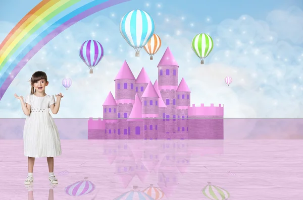 Little girl in front of a pink fairy castle — Stock Photo, Image