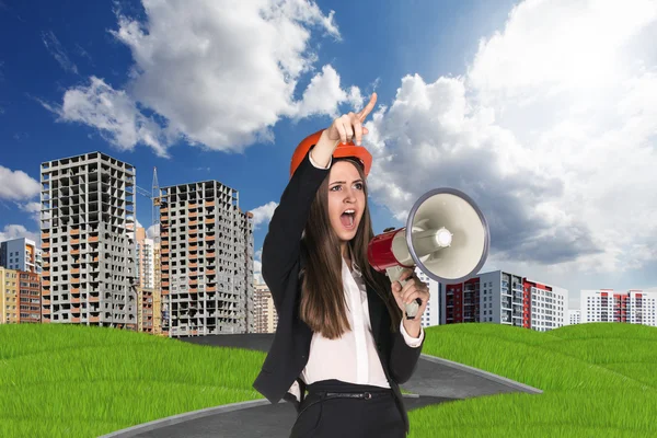 Woman in hardhat screaming in megaphone — Stock Photo, Image