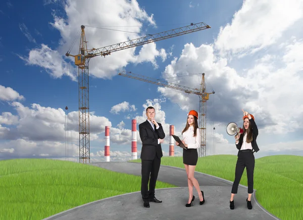 Business people in front af a factory — Stock Photo, Image