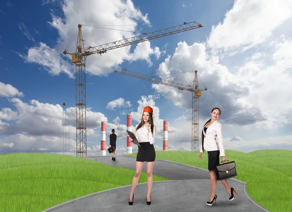 Business people in front af a factory — Stock Photo, Image