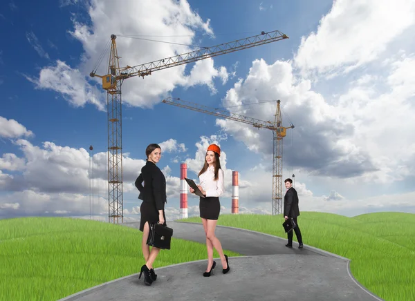 Business people in front af a factory — Stock Photo, Image