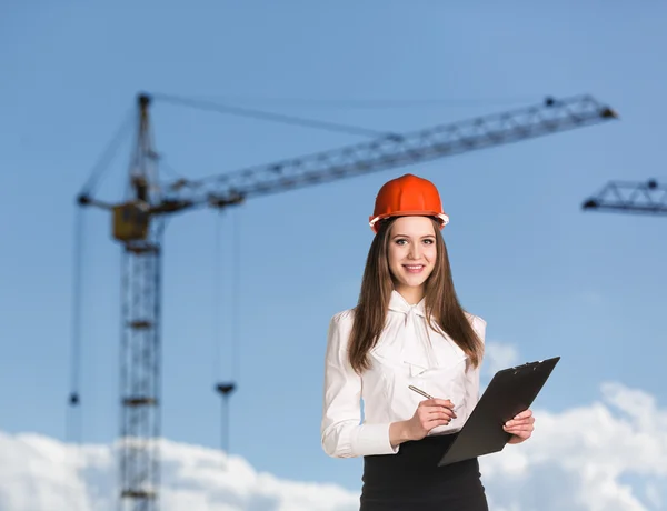 Smiling woman-builder in hardhat — Stock Photo, Image