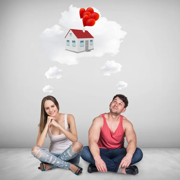 Loving couple sitting on floor in room — Stock Photo, Image