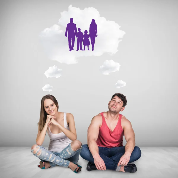 Loving couple sitting on floor in room — Stock Photo, Image