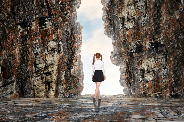 Schoolgirl in cave — Stock Photo, Image